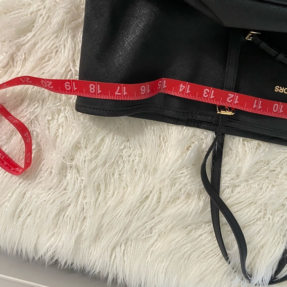 Black leather Michael Kors tote bag with gold-toned accents and flat handles. - Picture 10 of 12